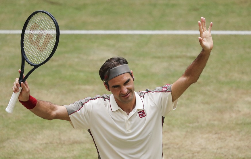 Roger Federer, of Switzerland, celebrates his victory over Pierre-Hugues Herbert, left, of France, in their semifinal match of the Halle Open tennis tournament in Halle, Germany, Saturday, June 22, 20 ...