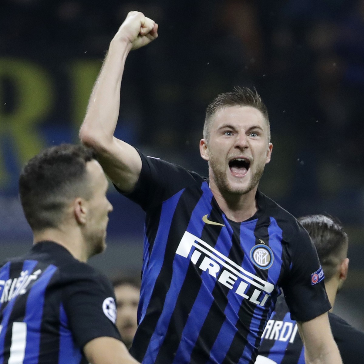 Inter defender Milan Skriniar, center, celebrates after his teammate Inter forward Mauro Icardi, scored his side's opening goal during the Champions League group B soccer match between Inter Mila ...