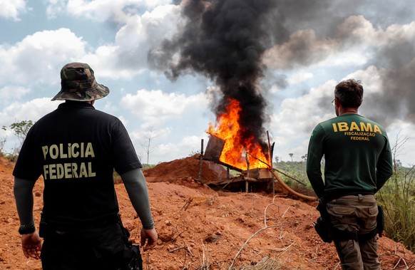 epa07806058 Environment agents and Federal Police destroy machinery used for illegal mining on the bank of river Xingu, 70km from Altamira town in the Amazon, Brazil, 31 August 2019. As the Amazon con ...