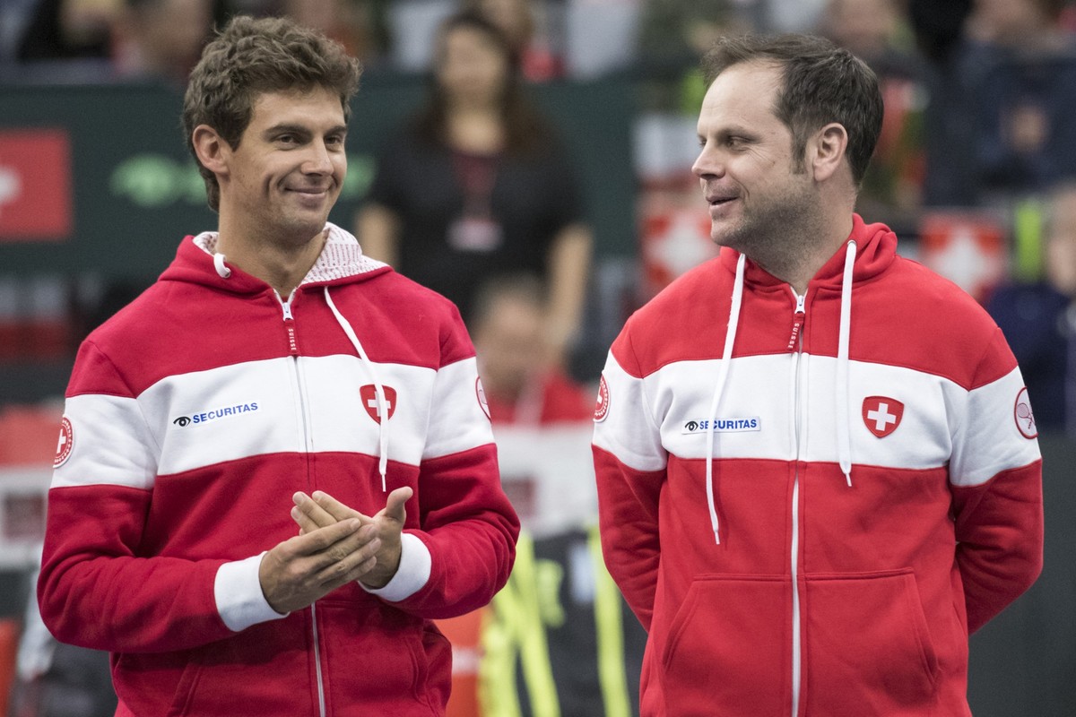Switzerland's Henri Laaksonen, and team captain Severin Luethi, during the double match of the Davis Cup qualification final round between Switzerland and Russia at the Swiss Tennis Arena in Biel ...