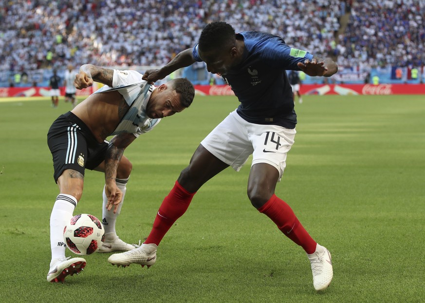 Argentina's Nicolas Otamendi, left, battles with France's Blaise Matuidi during the round of 16 match between France and Argentina, at the 2018 soccer World Cup at the Kazan Arena in Kazan, Russia, Sa ...