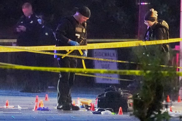 U.S. Secret Service Police examine and photograph evidence at a crime scene near the White House, Saturday, May 23, 2026, in Washington. The U.S. Secret Service shot a person near the White House on S ...