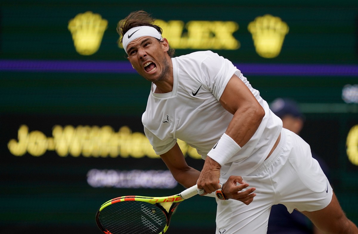 epa07699312 Rafael Nadal of Spain in action against Jo-Wilfried Tsonga of France during their third round match at the Wimbledon Championships at the All England Lawn Tennis Club, in London, Britain,  ...