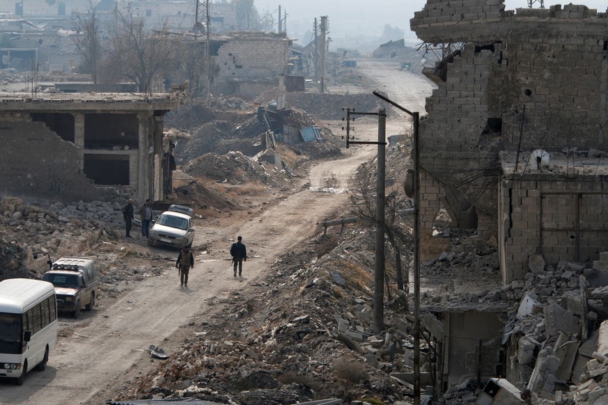 Forces loyal to Syria&#039;s President Bashar al-Assad walk past along a street in the government held Sheikh Saeed district of Aleppo, during a media tour, Syria December 12, 2016. REUTERS/Omar Sanad ...