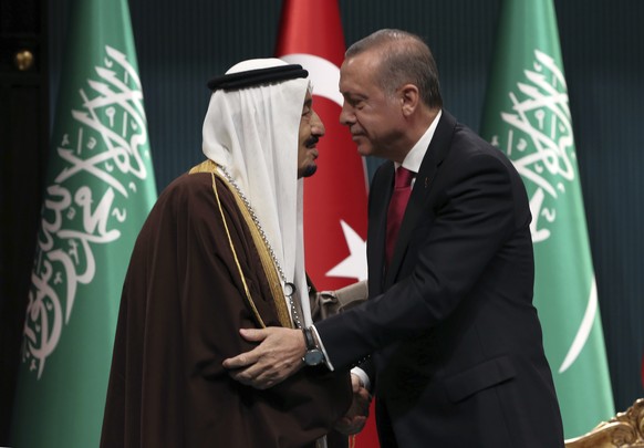 FILE - In this April 12, 2016 photograph, Turkish President Recep Tayyip Erdogan, right, and Saudi Arabia&#039;s King Salman embrace each other during a medal ceremony in Ankara, Turkey. The disappear ...