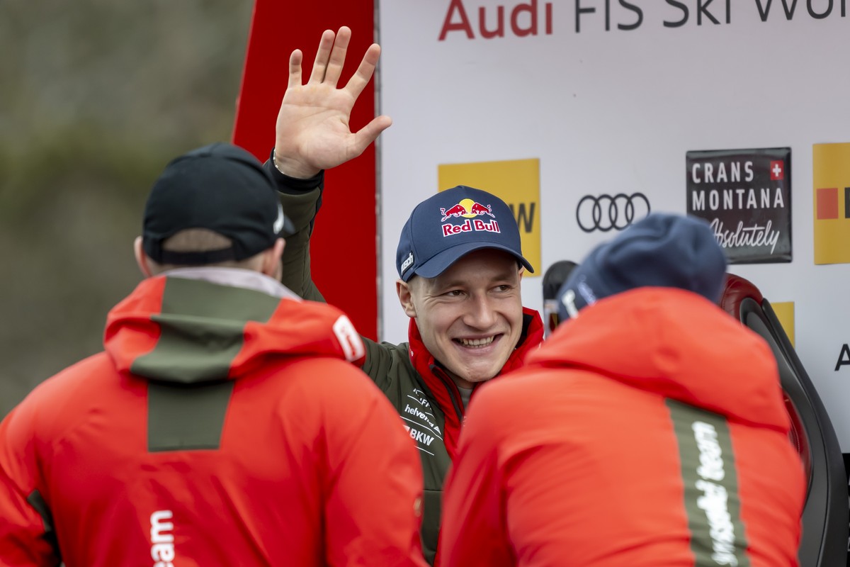 Marco Odermatt of Switzerland in front his teammates waves Swiss fans in the finish area during the men's Super-G race at the Alpine Skiing FIS Ski World Cup, in Crans-Montana, Switzerland, Sunda ...