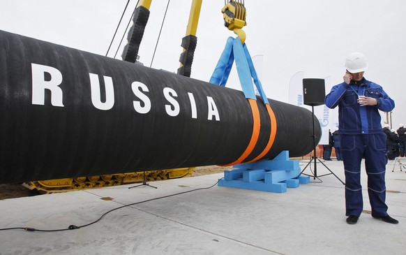 FILE - A Russian construction worker speaks on a mobile phone during a ceremony marking the start of Nord Stream pipeline construction in Portovaya Bay some 170 kms (106 miles) north-west from St. Pet ...