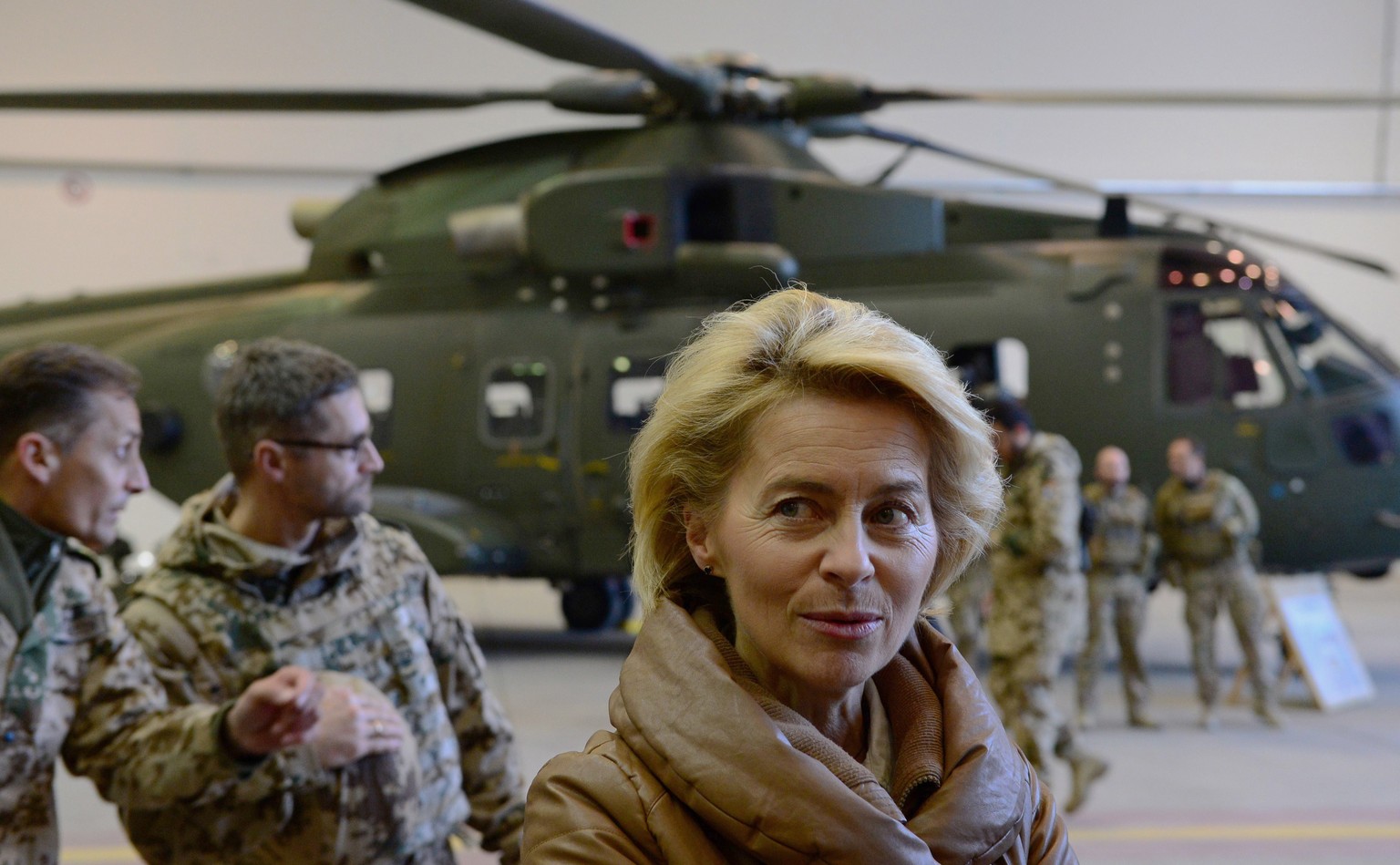 German Defense Minister Ursula von der Leyen, center, greets German helicopter pilots in a hangar at Camp Marmal in Mazar-i-Sharif, Afghanistan, Saturday, Dec. 13, 2014. Von der Leyen arrived in Afgha ...