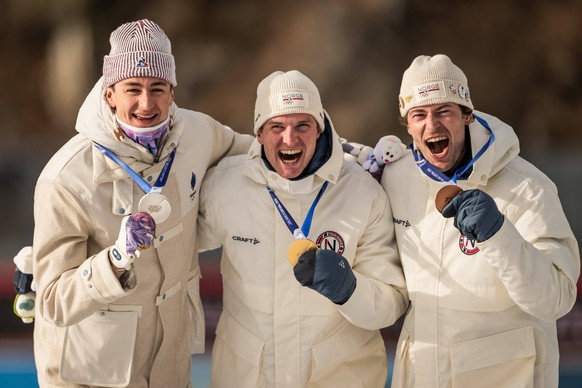 260210 Eric Perrot of France, Johan-Olav Botn of Norway and Sturla Holm Laegreid of Norway celebrate with their medals after competing men s biathlon 20 km individual during day 4 of the 2026 Winter O ...