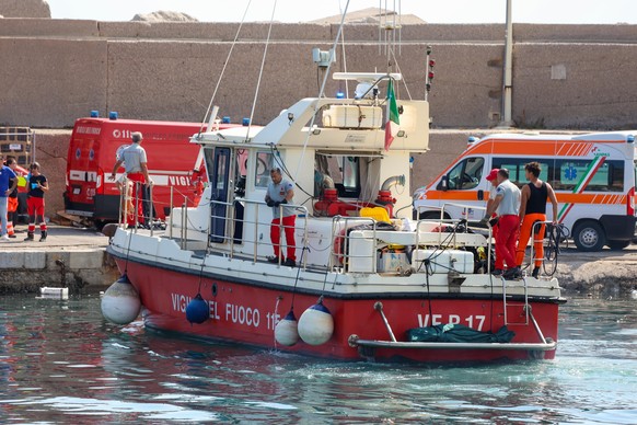 epa11554914 Ambulances with health workers wait on the pier as rescue operation continues for the missing people who were on board a sailboat that sank in Palermo, Sicily, Italy, 19 August 2024. At le ...