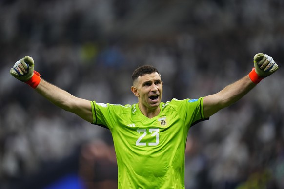 Argentina&#039;s goalkeeper Emiliano Martinez celebrates after he save a penalty during penalty shootouts during the World Cup final soccer match between Argentina and France at the Lusail Stadium in  ...