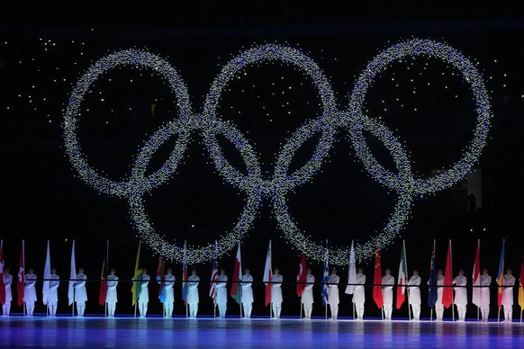 FILE - The Olympic rings are displayed during the closing ceremony of the 2022 Winter Olympics, on Feb. 20, 2022, in Beijing. A small band or protesters gathered Sunday, June 12, in central Tokyo and  ...