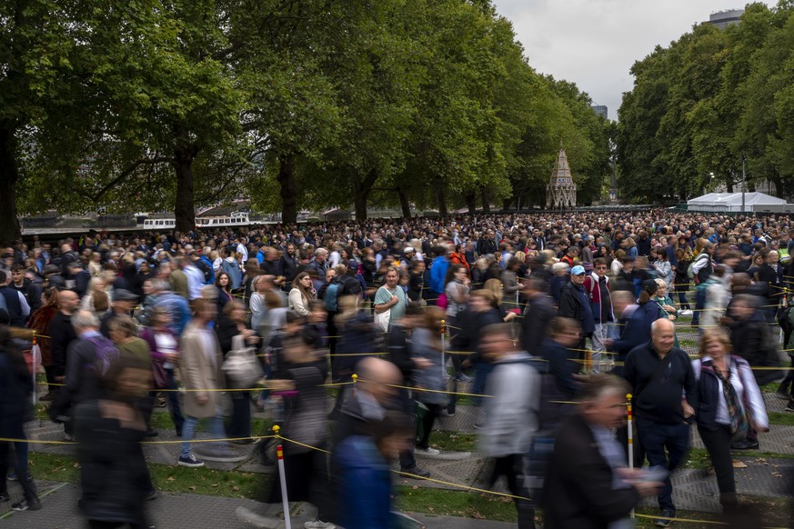 People queue to pay their respect to the late Queen Elizabeth II during the Lying-in State, outside Westminster Hall in London, Thursday, Sept. 15, 2022. The Queen will lie in state in Westminster Hal ...