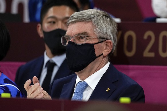 President of the IOC Thomas Bach wearing a face mask applauds as he watching the men&#039;s -73kg judo semifinal matches, at the 2020 Summer Olympics in Tokyo, Japan, Monday, July 26, 2021. (AP Photo/ ...