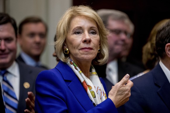 This photo taken Monday, March 27, 2017, shows Education Secretary Betsy DeVos waiting for President Donald Trump to arrive to sign various bills in the Roosevelt Room of the White House, in Washingto ...