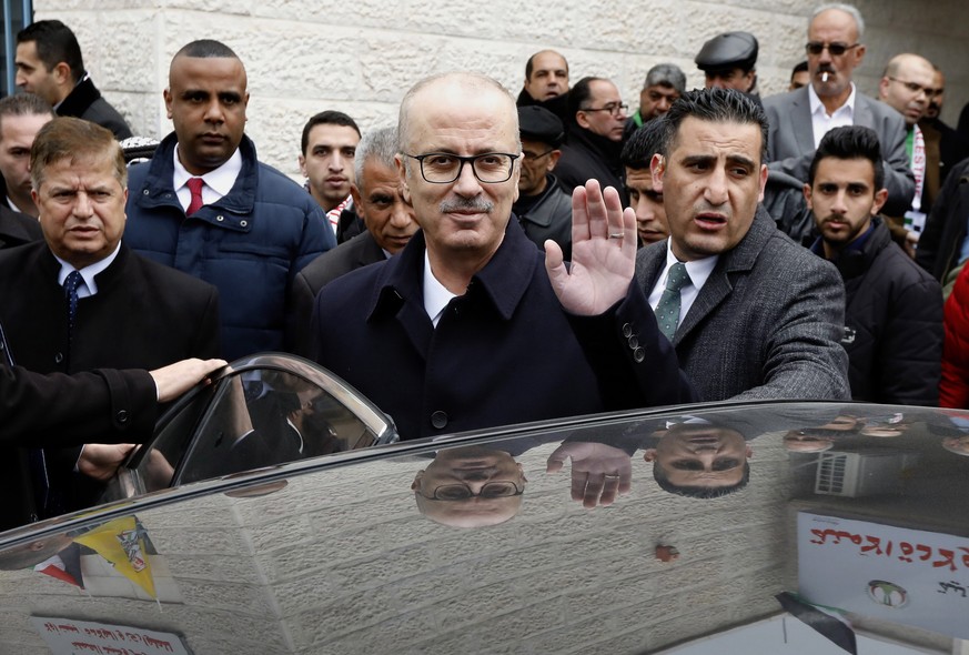 epa07327235 Palestinian Prime Minister Rami Hamdallah (C) waves as he attends an opening ceremony of a medical center in the West Bank village of Beit Ula, near Hebron, 28 January 2019. According to m ...