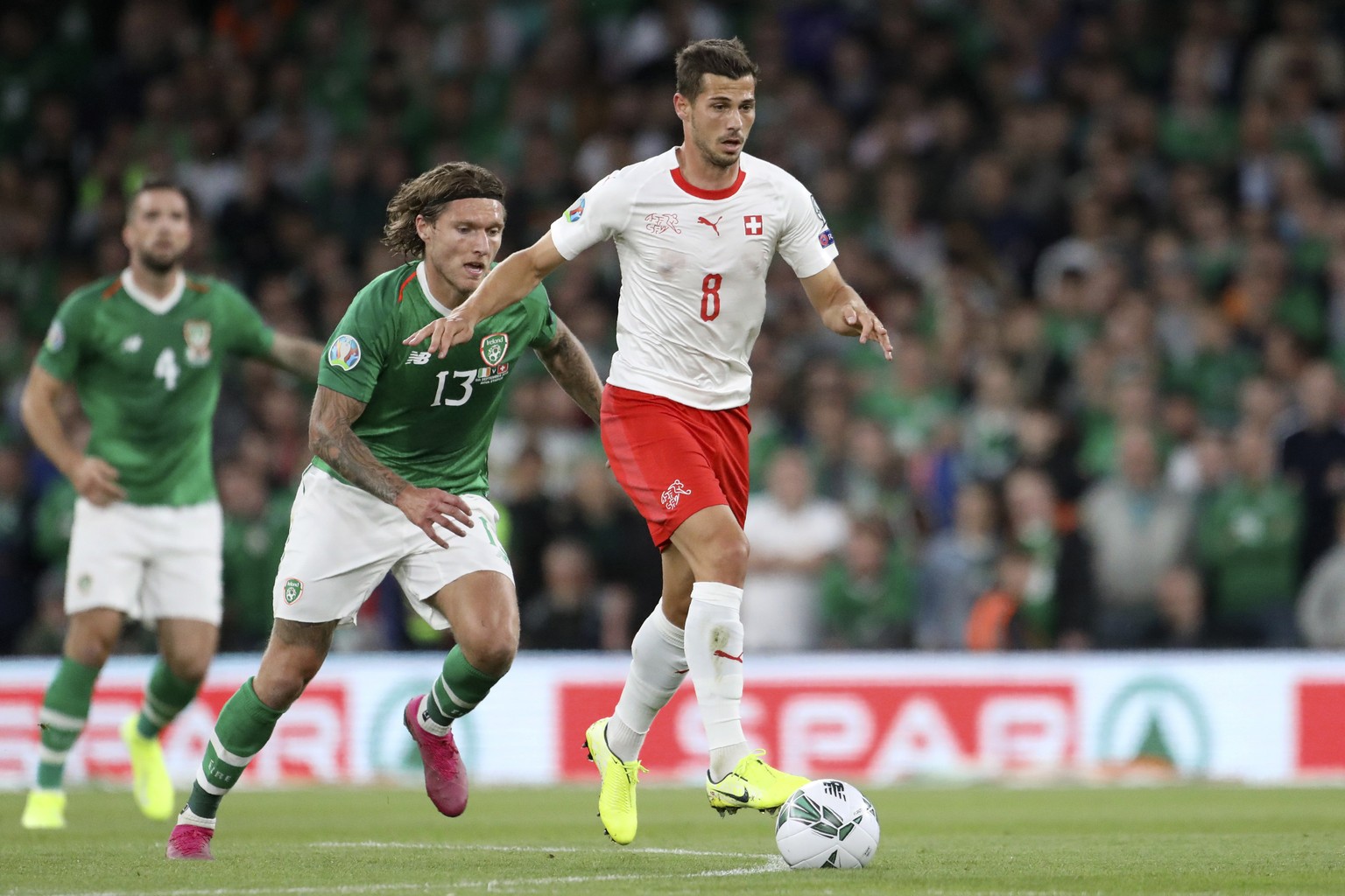 Switzerland&#039;s Remo Freuler runs with the ball away from Ireland&#039;s Jeff Hendrick, center, during the Euro 2020 group D qualifying soccer match between Ireland and Switzerland at the Aviva sta ...