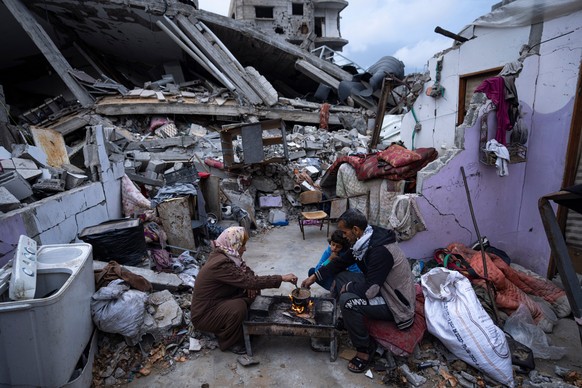 FILE.- Members of the Al-Rabaya family break their fast during the Muslim holy month of Ramadan outside their home, which was destroyed by an Israeli airstrike, in Rafah, southern Gaza Strip, on March ...