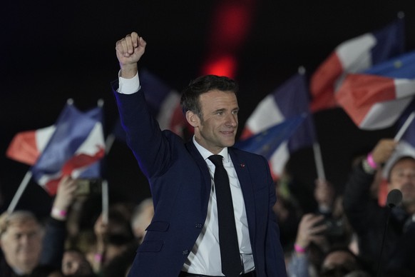 French President Emmanuel Macron celebrates with supporters in Paris, France, Sunday, April 24, 2022. Polling agencies projected that French President Emmanuel Macron comfortably won reelection Sunday ...