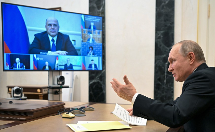 Russian President Vladimir Putin gestures while speaking during a meeting on economic issues via videoconference in Moscow, Russia, Thursday, Feb. 17, 2022. Russian Prime Minister Mikhail Mishustin is ...