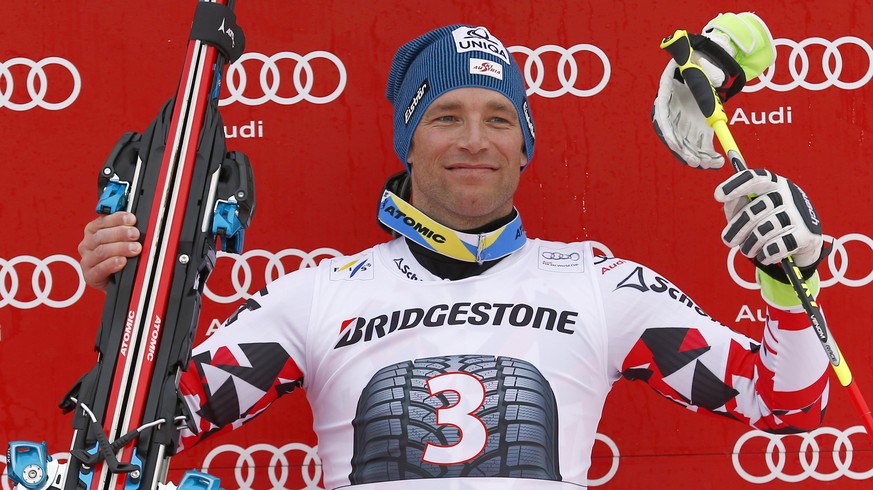 Austria's Benjamin Raich, third placed, celebrates on the podium at the end of an alpine ski, men's World Cup giant slalom competition in Garmish Partenkirchen, Germany, Sunday, March 1, 201 ...