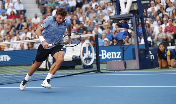 epa07815408 Stan Wawrinka of Switzerland turns to chase a lob from Daniil Medvedev of Russia during their quarter-finals round match on the ninth day of the US Open Tennis Championships the USTA Natio ...