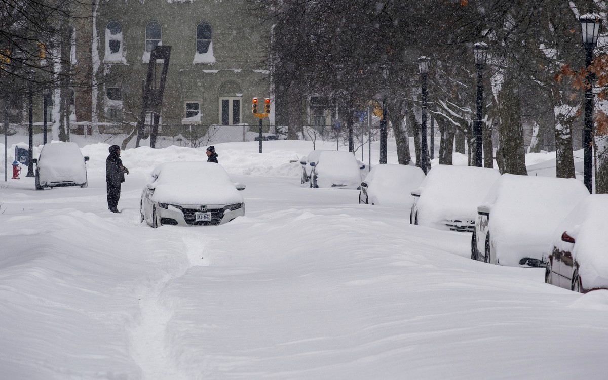 An abandoned car rests on a street in the Elmwood Village neighborhood of Buffalo, N.Y. Monday, Dec. 26, 2022, after a massive snow storm blanketed the city. Along with drifts and travel bans, many st ...