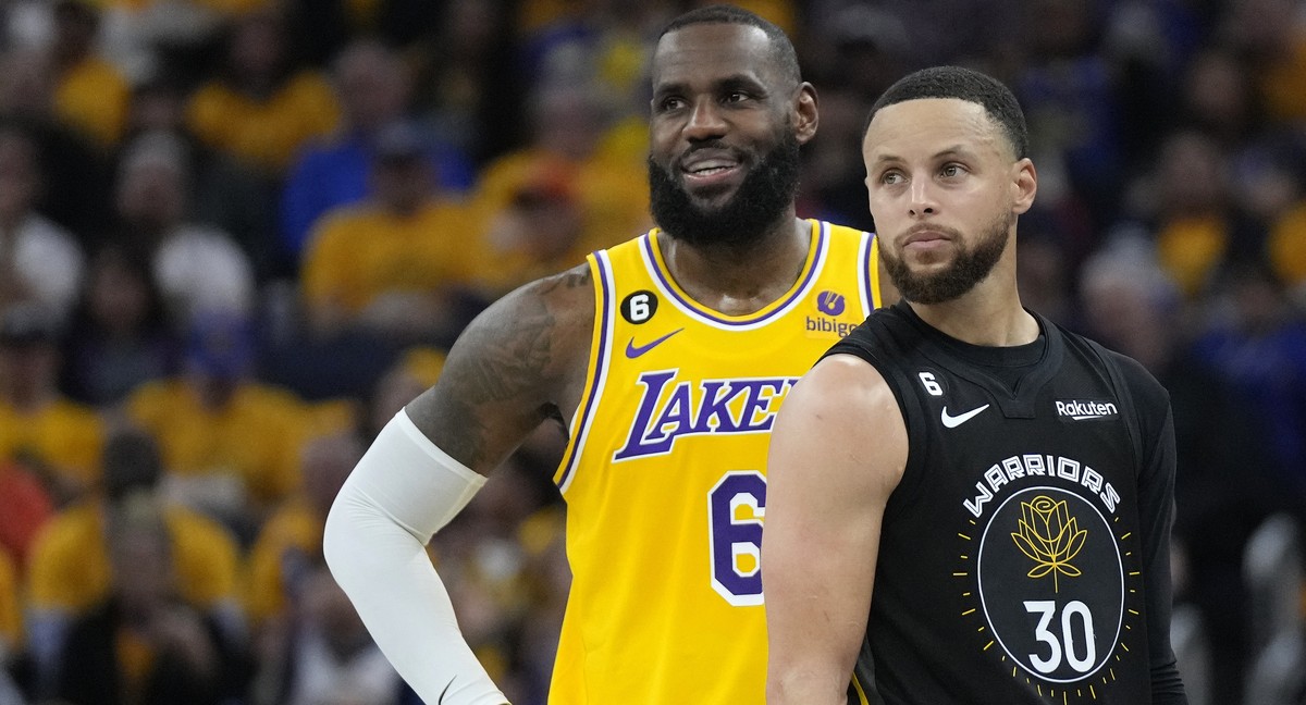 Los Angeles Lakers forward LeBron James (6) and Golden State Warriors guard Stephen Curry (30) stand together during the first half of an NBA basketball Western Conference semifinal game, Tuesday, May ...