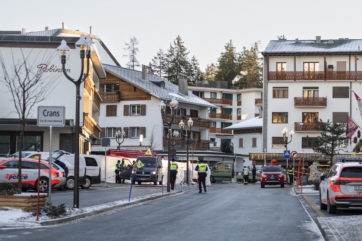 epa12620167 Police officers stand near the site where a fire broke out at Le Constellation bar and lounge following an explosion in the early hours of New Year's Eve, in Crans-Montana, Switzerlan ...