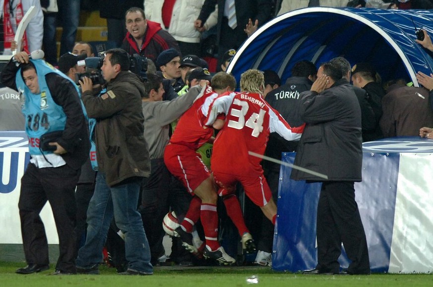 Swiss players Christoph Spycher and Valon Behrami hurry out of the stadium after the FIFA 2006 qualifying play-off second leg soccer match between Turkey and Switzerland at Sukru Saracoglu Stadium in  ...