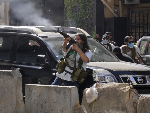 Supporters of a Shiite group allied with Hezbollah fire weapons during armed clashes that erupted during a protest in the southern Beirut suburb of Dahiyeh, Lebanon, Thursday, Oct. 14, 2021. It was no ...