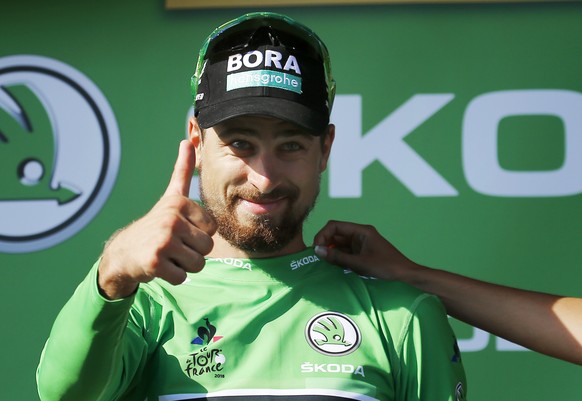 Slovakia&#039;s Peter Sagan, wearing the best sprinter&#039;s green jersey celebrates on the podium after the fourteenth stage of the Tour de France cycling race over 188 kilometers (116.8 miles) with ...