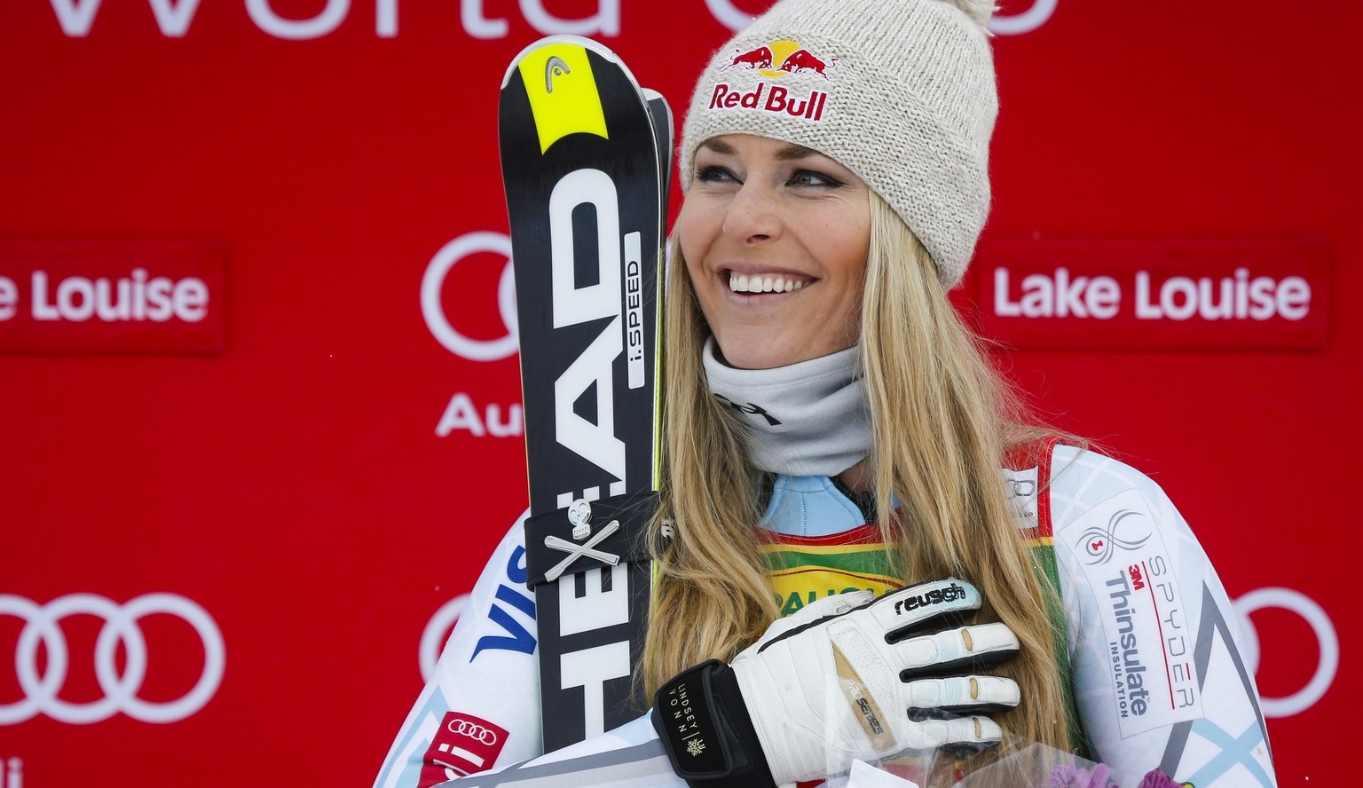 Lindsey Vonn, of the United States, covers her heart during the playing of her national anthem as she celebrates her win on the podium following the women&#039;s World Cup super-G skiing event in Lake ...