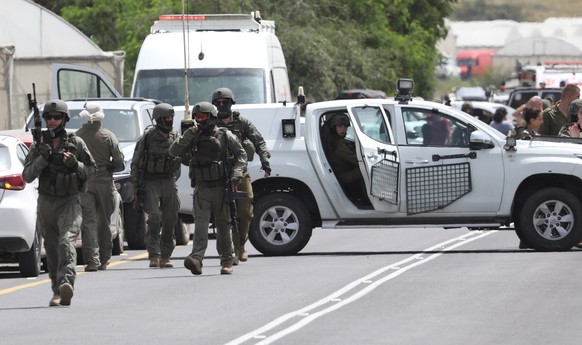 epa10563061 Israeli security personnel search the scene of a shooting attack at the Hamra junction in the Jordan Valley, 07 April 2023. According to the IDF, at least two Israeli women were killed and ...