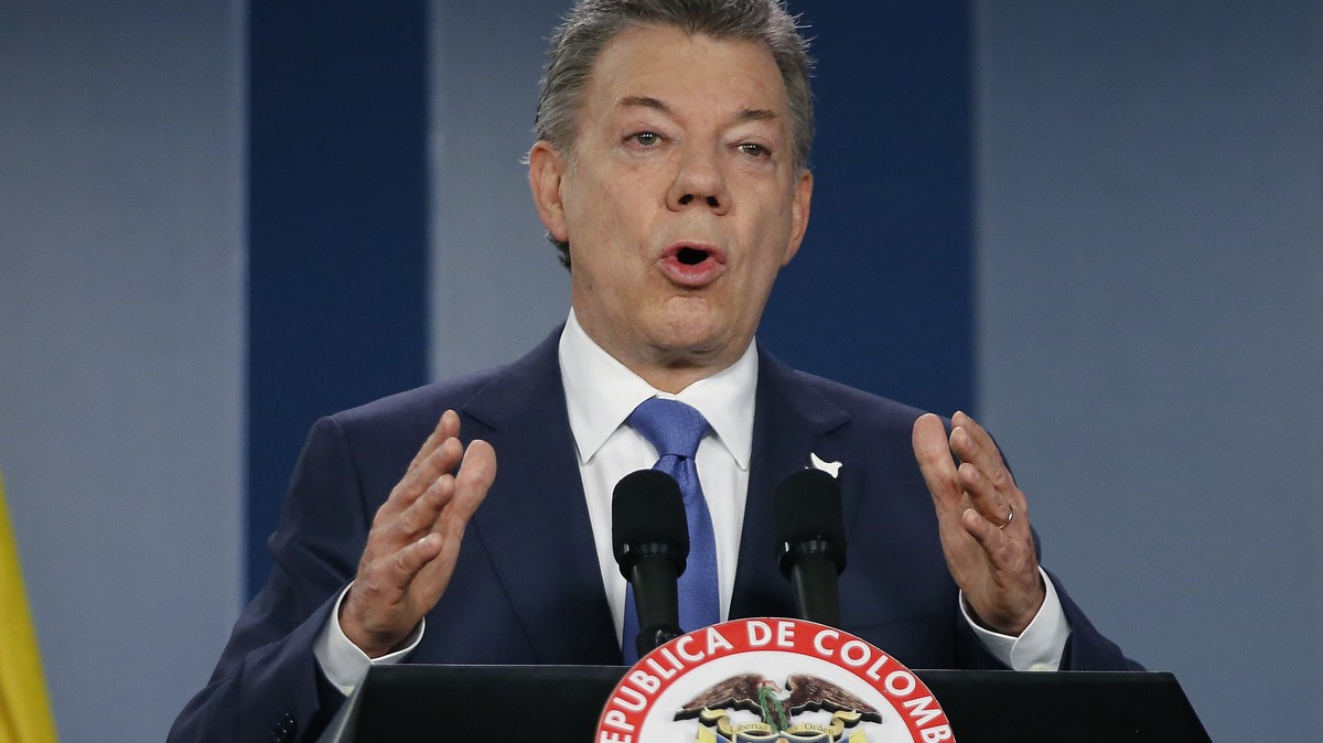 FILE - In this Wednesday, Oct. 4, 2016 file photo, Colombia’s President Juan Manuel Santos delivers a statement to the press after meeting with former President Alvaro Uribe and other opposition leade ...