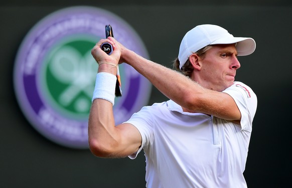 LONDON, ENGLAND - JULY 06: Kevin Anderson of South Africa returns a shot in his Gentlemen&#039;s Singles Fourth Round match against Novak Djokovic of Serbia during day seven of the Wimbledon Lawn Tenn ...