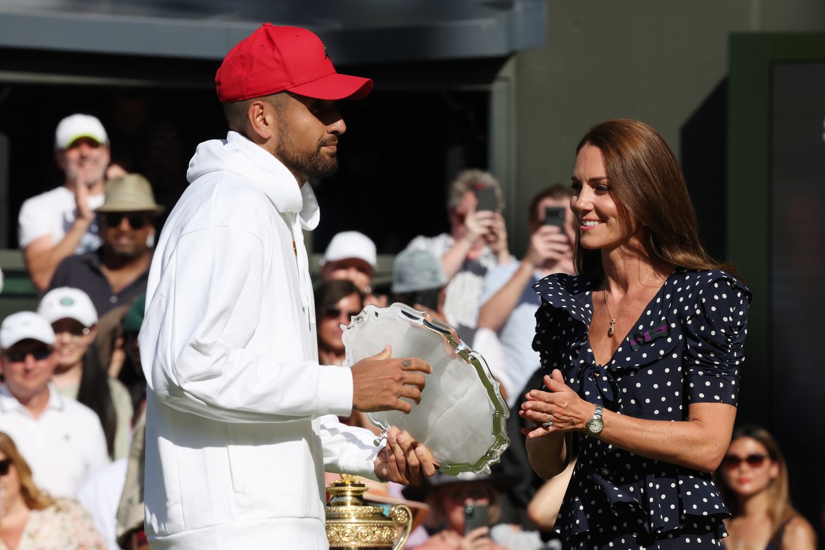 epa10064102 Catherine, Duchess of Cambridge, hands Nick Kyrgios of Australia the runner-up trophy after the men's final match against Novak Djokovic of Serbia at the Wimbledon Championships, in W ...
