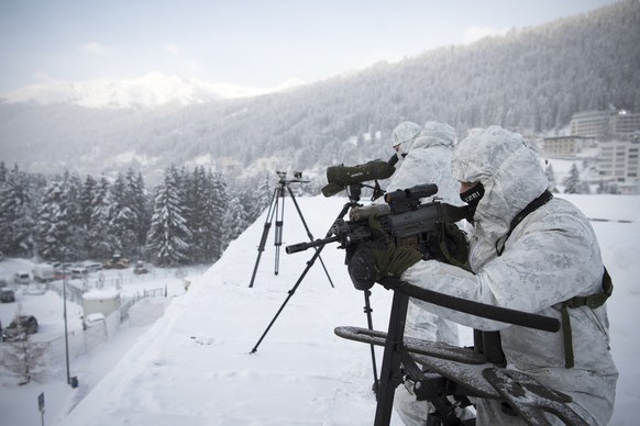 Police is on guard on top of the Congress Center on the eve of the 47th Annual Meeting of the World Economic Forum, WEF, in Davos, Switzerland, Monday, January 16, 2017. The overarching theme of the M ...