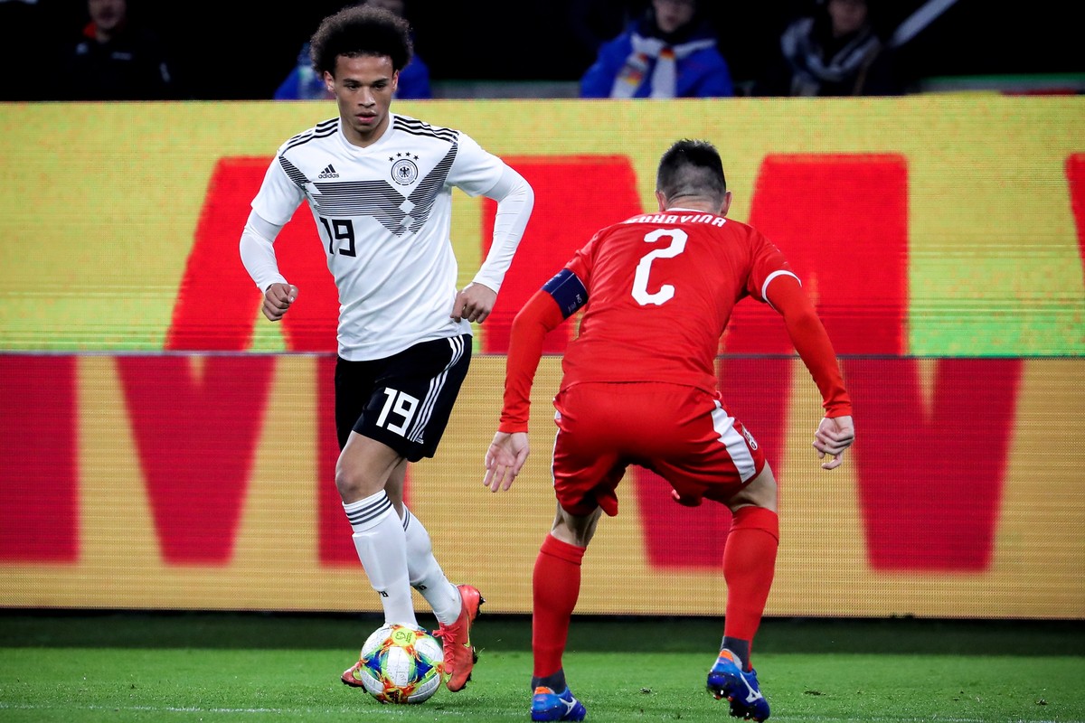 epa07451615 Germany's Leroy Sane (L) in action against Serbia's Antonio Rukavina (R) during the international friendly soccer match between Germany and Serbia in Wolfsburg, Germany, 20 March ...