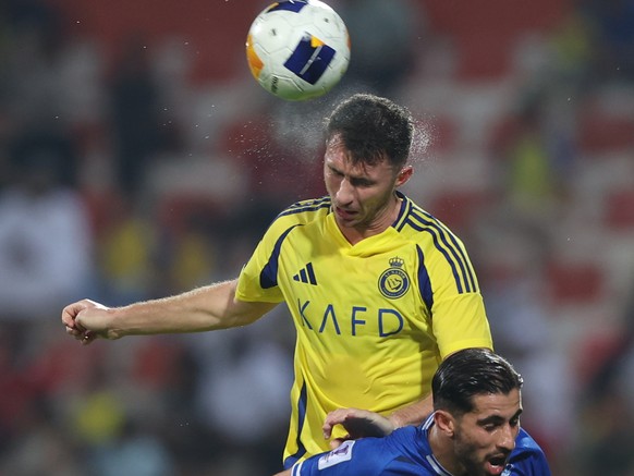 epa11675359 Aymeric Laporte (Back) of Al-Nassr and Alereza Koushki of Esteghlal in action during the AFC Champions League soccer match between Esteghlal FC and Al Nassr FC in Dubai, United Arab Emirat ...