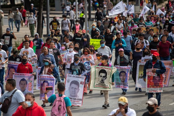 epa10035918 Hundreds of people protest the disappearance of the 43 Ayotzinapa students, in Mexico City, Mexico, 26 June 2022. Relatives and friends of the 43 students kidnapped from Ayotzinapa Rural T ...
