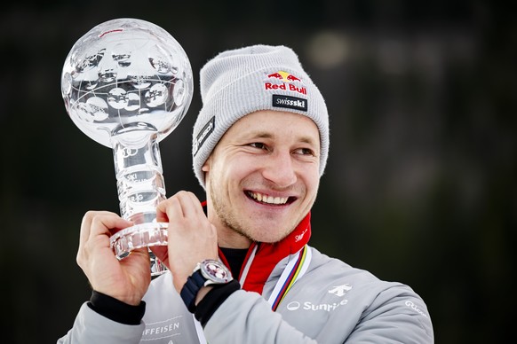 epa12841311 Marco Odermatt of Switzerland celebrates with the Men's Super G overall leader's crystal globe trophy after the podium ceremony for the Super G at the FIS Alpine Skiing World Cup ...