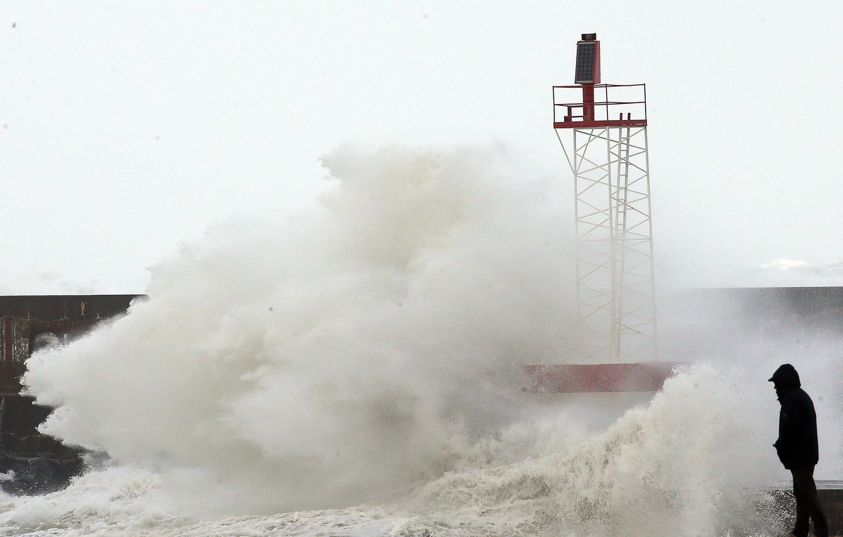 A person watches the sea in Anglet, southwestern France, Sunday, Nov.3, 2019. Most of the French regions are on alert for violent storms and high winds. (AP Photo/Bob Edme)
