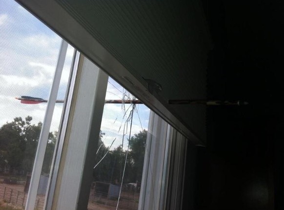 Neighbor shoots arrow at house