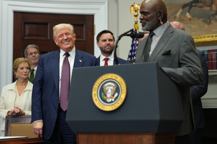 epa12275889 US President Donald Trump (L), and Lawrence Taylor (R), former New York Giants linebacker, during an executive order signing ceremony in the Roosevelt Room of the White House in Washington ...