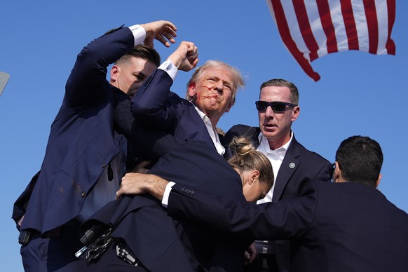 FILE - Republican presidential candidate former President Donald Trump is surrounded by U.S. Secret Service agents at a campaign rally, July 13, 2024, in Butler, Pa. (AP Photo/Evan Vucci, File)
Trump  ...