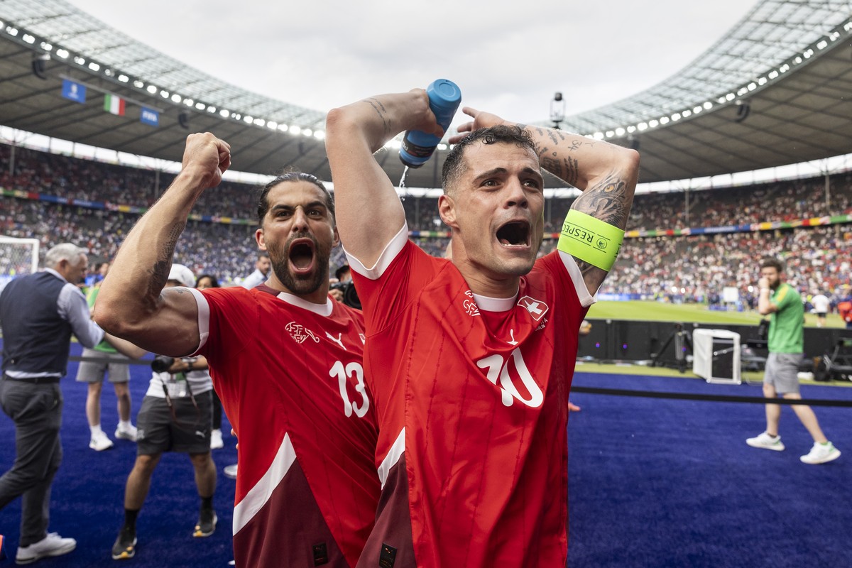 Switzerland's Granit Xhaka, right, and Ricardo Rodriguez celebrate winning 2:0 against Italy after a round of 16 match between Switzerland and Italy at the Euro 2024 soccer tournament in Berlin,  ...