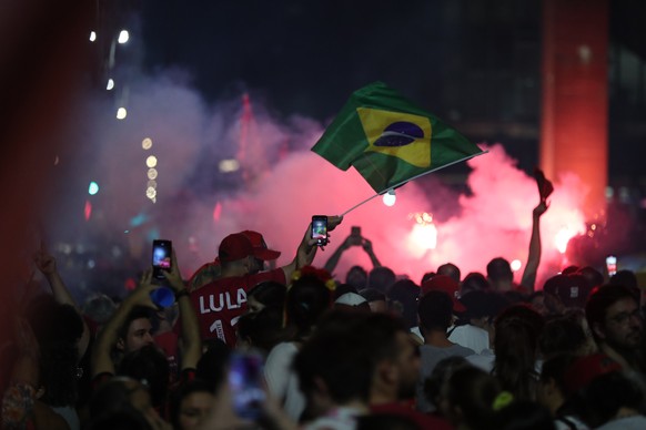 epa10276322 Supporters of the Brazilian presidential candidate Luiz Inacio Lula da Silva celebrate the results of the second round of presidential elections, at the Paulista Avenue in Sao Paulo, Brazi ...