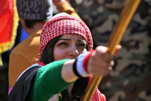 A woman waves an Iraqi flag during a protest in Tahrir Square, Baghdad, Iraq, Thursday, Feb. 13, 2020. Hundreds of women took to the streets of central Baghdad and southern Iraq on Thursday in defianc ...