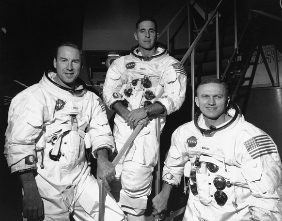 FILE - In this Dec. 18, 1968, file photo, Apollo 8 astronauts, from left, James Lovell, command module pilot; William Anders, lunar module pilot; and Frank Borman, commander, stand in front of mission ...